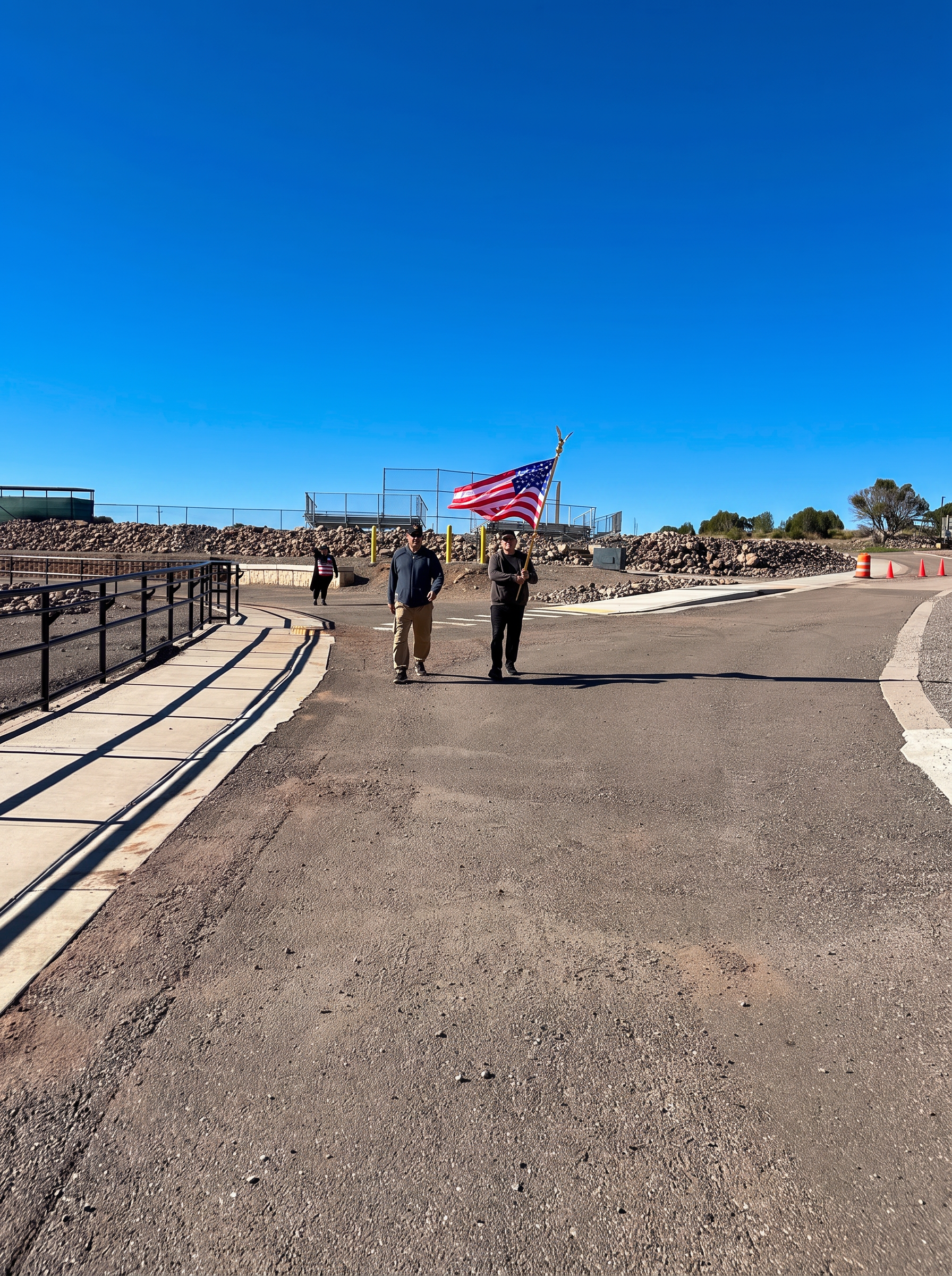 Marchers carrying the American flag along the Fort Bayard route